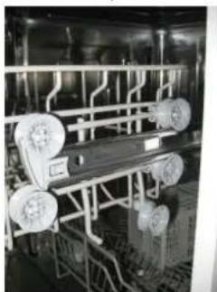 Industrial machinery setup with multiple wheels and piping (no visible text or symbols).