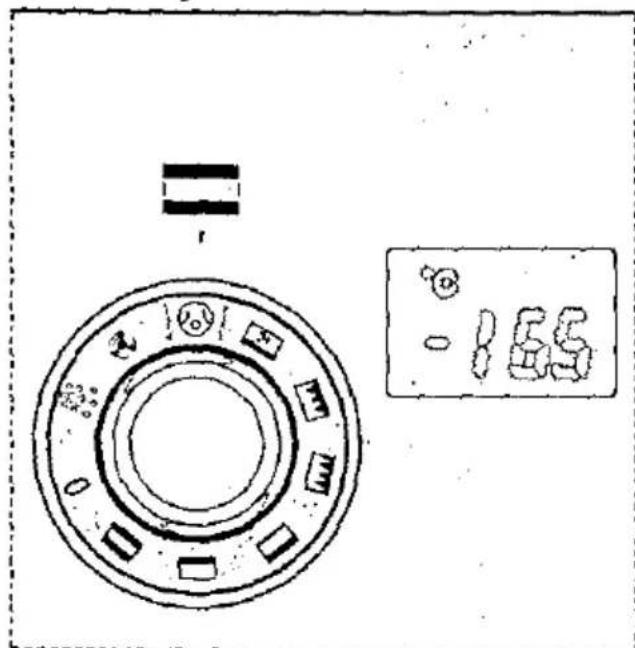 Technical diagram of a mechanical component with circular features and a digital display showing '165' units.
