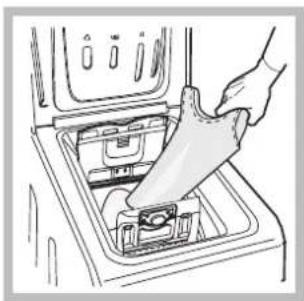 Line drawing of a hand inserting a plastic bag into a shared appliance inside a washing machine (no text or symbols)
