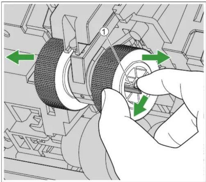 Mechanical assembly diagram showing a hand operating a gear mechanism with green arrows indicating motion direction (no text or symbols present).