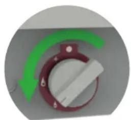 Close-up of a red rotary knob with white dial and green arrow indicator (no text or symbols)