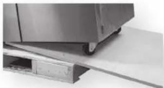 Close-up of a metallic kitchen or appliance with a flat surface and a small rectangular object on a base (no visible text or symbols)