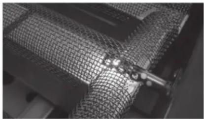 Close-up of a mesh textile or mesh structure with a metal clip, no visible text or symbols