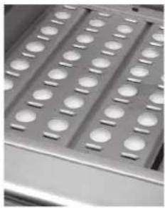 Close-up of a metallic tray with multiple circular indentations (no text or symbols visible)