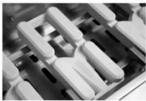 Close-up of white plastic mechanical components arranged in a grid pattern (no visible text or symbols)