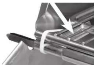 Close-up of a mechanical component with a white arrow pointing to a textured surface (no visible text or symbols)