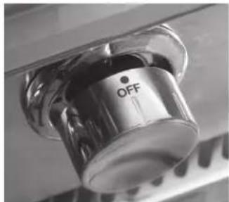 Close-up of a metallic rotary knob labeled 'OFF', mounted on a surface. No other text or symbols visible.