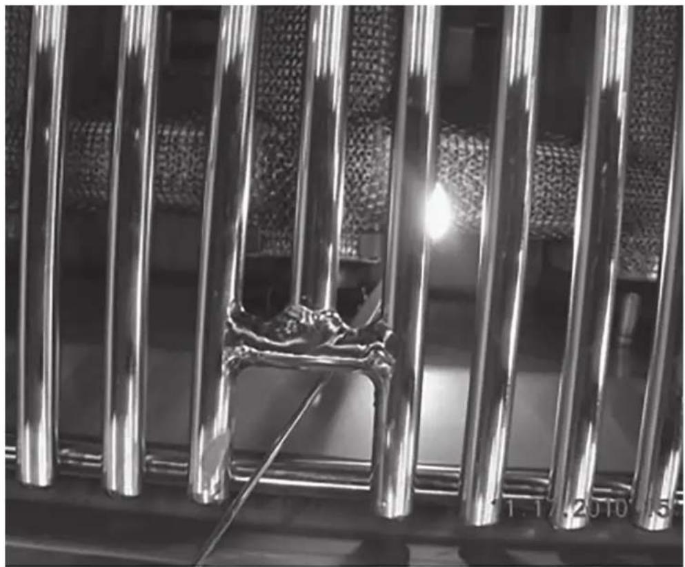 Close-up of metallic vertical bars with a visible crack and a tool, no text or symbols present.