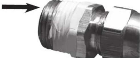 Close-up of a metallic mechanical connector with a black arrow pointing to it (no text or symbols visible)