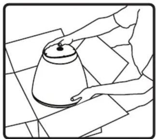 Line drawing of a person handling a large cylindrical object on a tiled floor (no text or symbols)