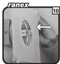 Close-up of a hand holding a white mechanical component with a circular cutout, no visible text or symbols