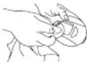 Line drawing of a hand holding an object, possibly a tool or device (no text or symbols present)