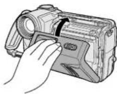 Hand inserting a camera into a digital device (no text or symbols visible)