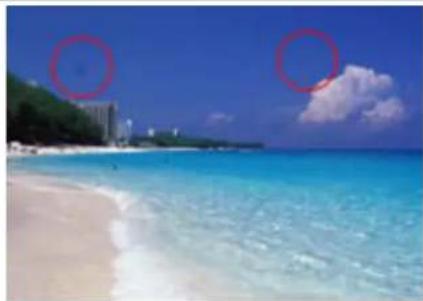 Beach scene with turquoise water, sandy beach, and two red circles highlighting the sky (no text or symbols)