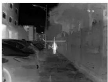Night street scene with a person walking, no visible text or symbols