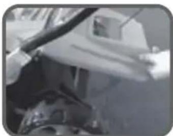 Close-up of a person's arm and hand interacting with a vehicle.