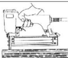 Line drawing of a hand using a power tool to press a machine (no text or symbols present)