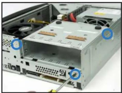 Interior view of a computer drive chassis showing CPU socket, drive bays, and cable (no text or symbols visible)