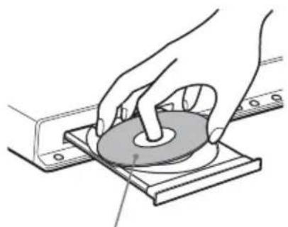 Illustration of hands operating a circular component on a base plate (no text or symbols visible)