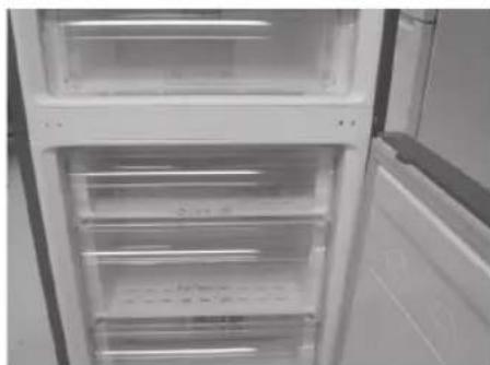 Interior view of a refrigerator with open doors and visible door covers (no text or symbols).