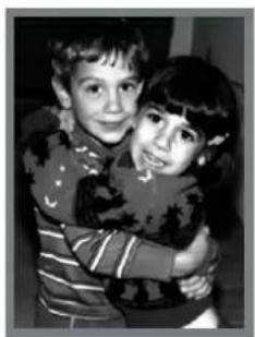 Black-and-white photo of two children embracing, one in striped shirt (no text or symbols visible)