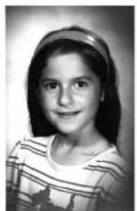 Black-and-white portrait of a young girl wearing a striped top and headband (no text or symbols visible).