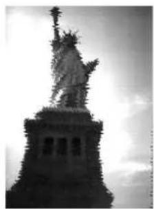 Black-and-white photo of the Statue of Liberty on a pedestal, no visible text or symbols.