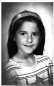 Black-and-white portrait of a young girl with shoulder-length hair and a striped top (no text or symbols visible).