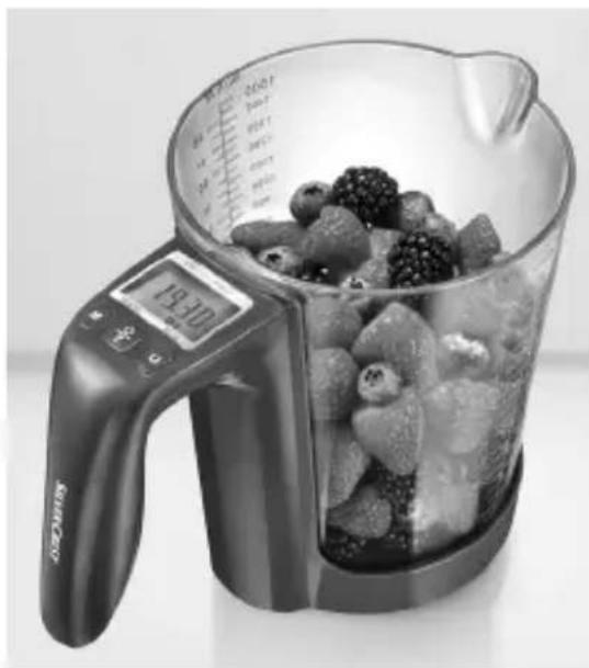 Black-and-white photo of a digital kitchen blender with a glass bowl filled with berries and fruit, no visible text or symbols.