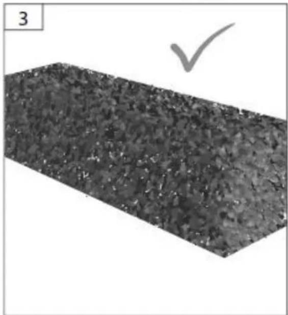 Close-up of a textured rectangular surface with a checkmark symbol above it (no text or symbols present)