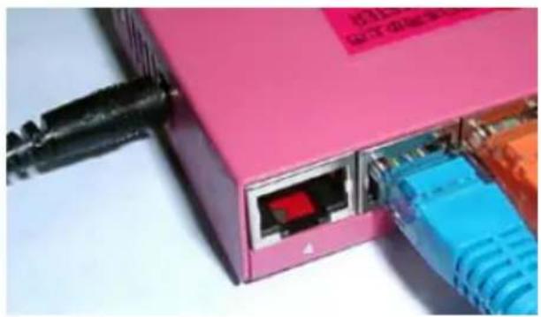 Close-up of a pink network switch with visible ports and connectors (no readable text or symbols)