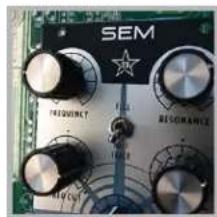 Close-up of a circuit board with labeled knobs and a star symbol (no readable text or numbers)