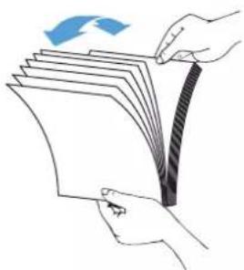 Illustration of hands holding a folded paper with a blue arrow indicating rotation (no text or symbols)