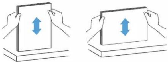 Two identical diagrams showing hands holding a rectangular object with bidirectional arrows, placed on a base (no text or symbols)