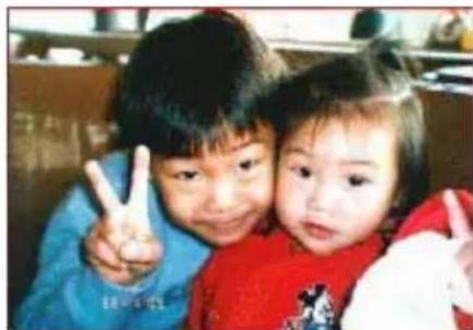 Two children making peace signs together (no visible text or symbols)