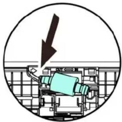 Diagram of a mechanical device inside a circular frame, showing a downward arrow and component layout (no text or symbols)