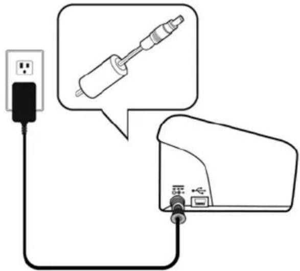 Diagram showing a plug connected to a device via cable, with an illustration of a soldering tool interacting with the plug (no text or symbols present)
