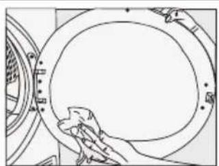 Line drawing of a hand cleaning a circular mechanical component (no text or symbols)