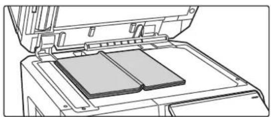 Line drawing of an open printer with a stack of documents inside (no text or symbols)