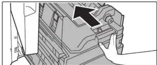 Diagram showing a hand pressing a component on a mechanical device, with an arrow indicating direction, with no text or symbols present.