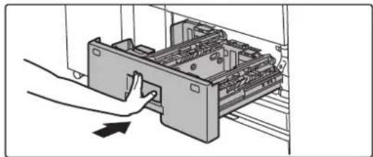 Illustration of a hand inserting a device into a rack with a handle, showing internal components (no text or symbols)