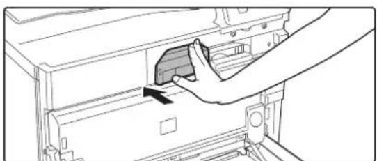 Line drawing of a hand inserting a component into a device (no text or symbols visible).