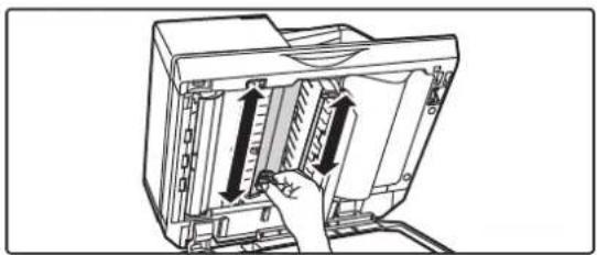 Illustration of a computer monitor with an open panel and a hand inserting a cable (no text or symbols visible)