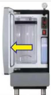 Interior view of a laboratory appliance with a yellow arrow pointing to a closed chamber (no text or symbols visible)