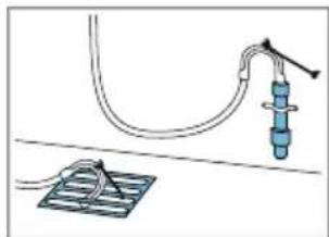 Simple line drawing of a medical or electrical setup with tubing, wires, and a grid base (no text or symbols)