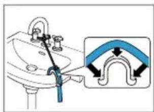 Diagram showing a hand holding a blue tool near a sink, with an inset illustrating the curved pipe connection.