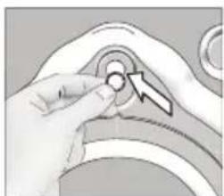 Close-up of a hand adjusting a circular component with a directional arrow (no text or symbols visible)