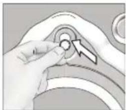 Close-up of a hand adjusting a circular component with an arrow, no visible text or symbols.
