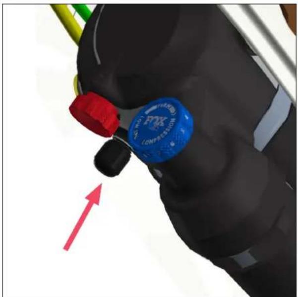 Close-up of a gloved hand holding a blue and red cap labeled 'MAX COMPRESSION', with a red arrow pointing upward (no text or symbols on the object itself)