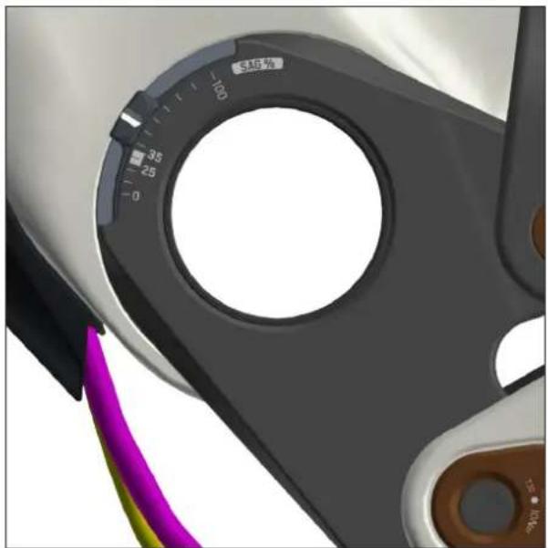 Close-up of a mechanical component with a circular dial and color-coded cable (no text or symbols visible)